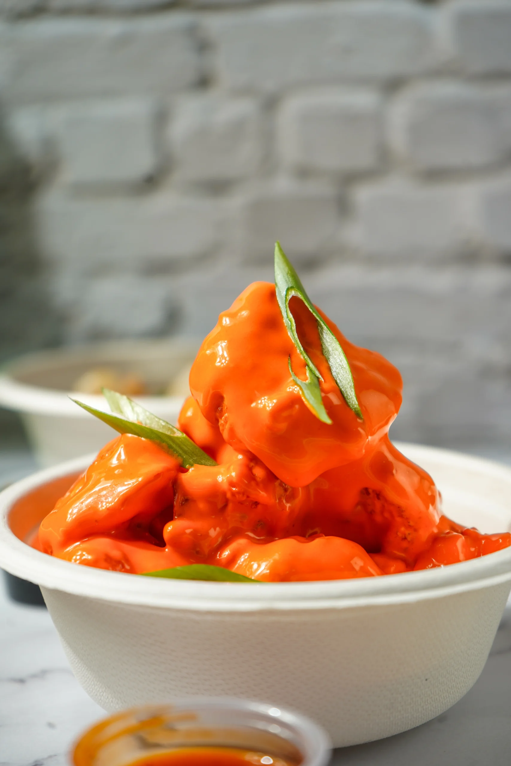 Dynamite shrimp appetizer with crispy fried shrimp in spicy mayo sauce served on a plate